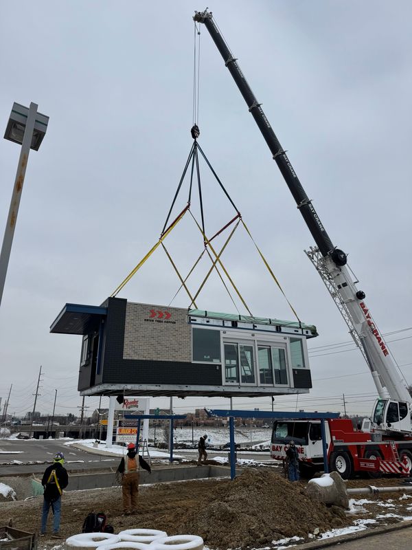 A crane drops the new 7 Brew stand in its lot on Turfway Road in Florence.