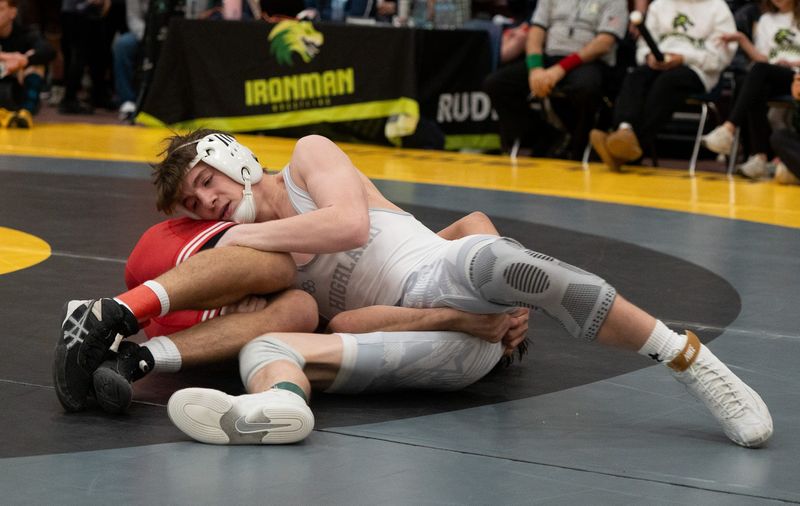 Highland’s Brandon Bickerton wrestles Lake Highland Prep’s Liam Davis at the Ironman wrestling tournament Day 1 at Walsh Jesuit High School in Cuyahoga Falls on Dec. 12, 2025.