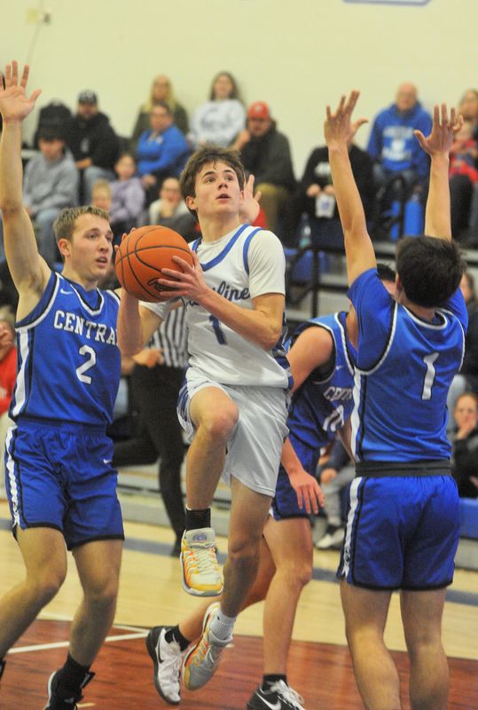 Crestline's Kody Lawhorn splits Central Christian's Drew Badertscher (2) and Preston Clark (1) for a layup.