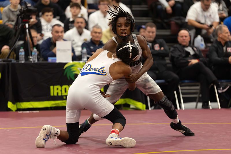 Streetsboro’s Jarreau Walker wrestles Warren Township’s Caleb Noble in the 113-pound third-place match at the Ironman wrestling tournament at Walsh Jesuit High School, Saturday, Dec. 13, 2025.