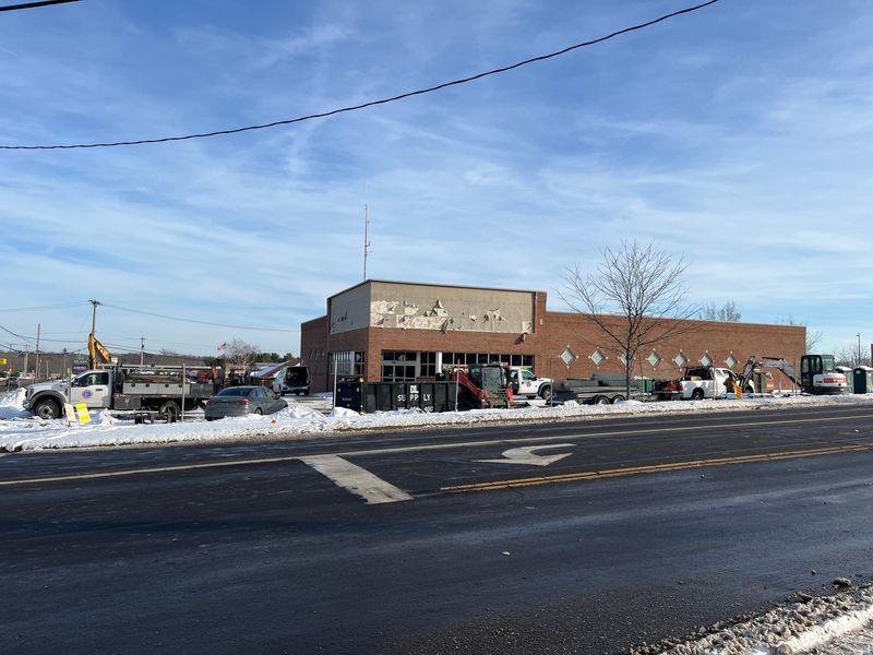 Contractors on Dec. 16 work to convert the former Rite Aid drugstore building on the southeast corner of Middlebranch Avenue NE and Easton Street NE into a car wash.