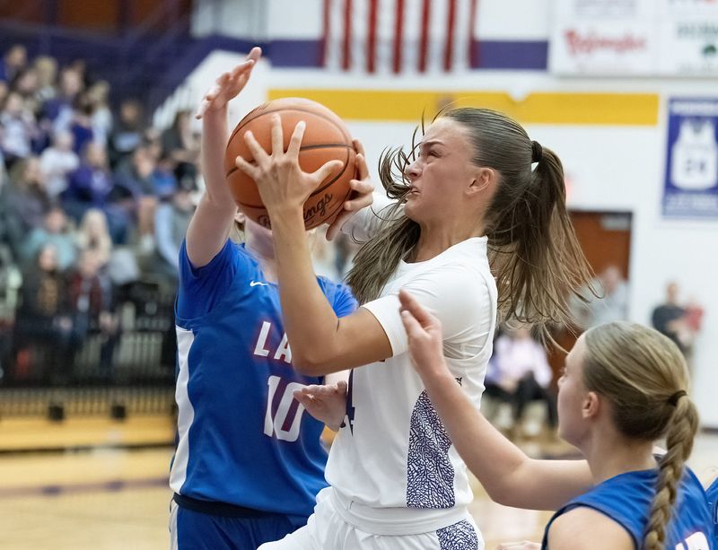 Jackson’s Maddie Lepley drives against Lake’s Allie Kerscher on Wednesday, Dec. 17, 2025.