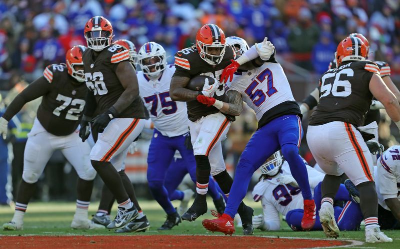 Cleveland Browns running back Raheim Sanders (35) rushes for yards against Buffalo Bills defensive end AJ Epenesa (57) during the second half of an NFL football game at Huntington Bank Field, Dec. 21, 2025, in Cleveland, Ohio.