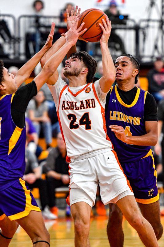 Ashland's Paxon Ediger powers his way to the basket past Lexington's Dantrell Hughes in a mid-season matchup.