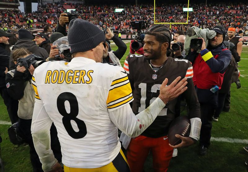 Browns quarterback Shedeur Sanders shakes hands with Pittsburgh Steelers quarterback Aaron Rodgers after a game won by the Browns, Dec. 28, 2025, in Cleveland.
