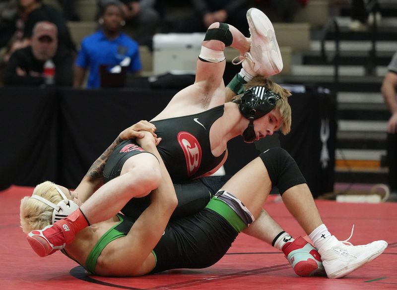 Dublin Coffman’s Loc Webber tangles with Brecksville’s Rylan Seacrist in the 113 pound weight class during the championship round of the Brecksville Invitational Holiday Tournament at Brecksville-Broadview Heights High School on Dec. 30, 2025.