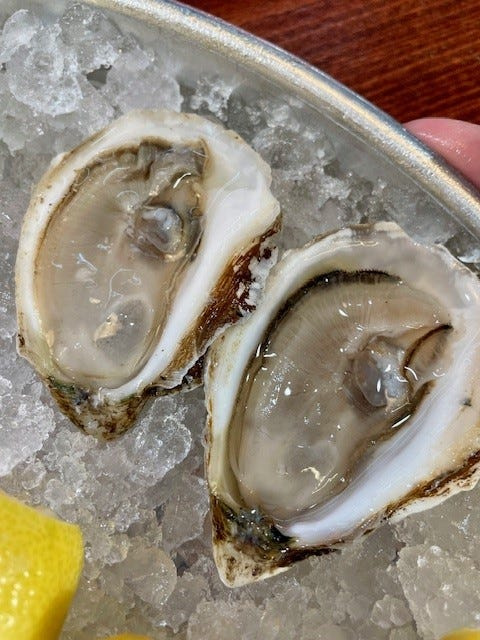 COLO Market & Oyster Bar sells fresh seafood at its retail counter and offers a menu of oysters and prepared seafood dishes for customers at North Market Downtown in Columbus.