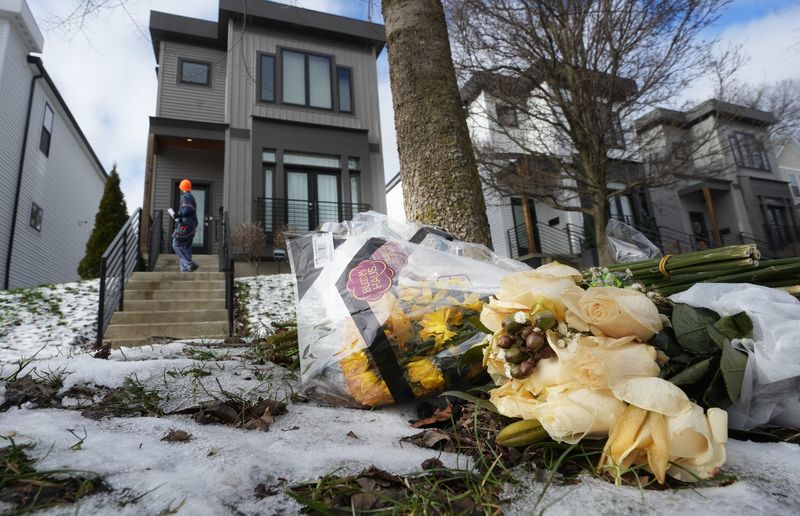 Flowers adorn the curb outside the home where Columbus police responded to 1411 N. 4th St. Dec. 30 where they found Monique Tepe, 39, and Spencer Tepe, 37, dead at the residence.