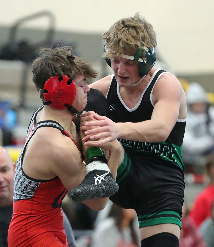 Crestwood’s Rocco Wrobel, left, looks for a takedown against Mogadore’s Caileb Tomkins during their 126 pound match in the championship round of the Portage County Tournament, Jan. 3, 2026, in Garrettsville, Ohio.