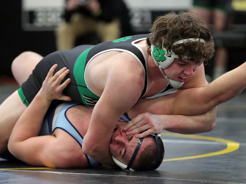Mogadore’s Dylan Benedum, top, wrestles Rootstown’s Kiel Reuting during their 215 pound match in the semifinal round of the Portage County Tournament, Jan. 3, 2026, in Garrettsville, Ohio.