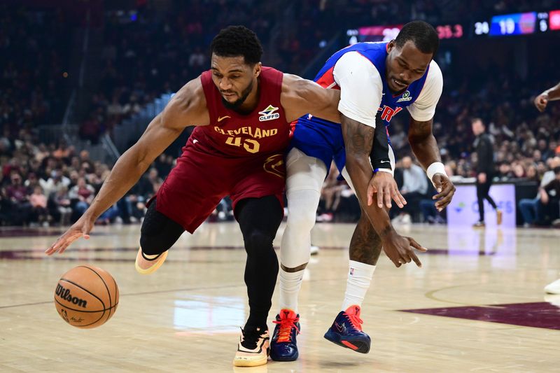 Cleveland Cavaliers guard Donovan Mitchell (45) goes for a loose ball against Detroit Pistons guard Javonte Green (31) during the first half at Rocket Arena in Cleveland on Sunday, Jan. 4, 2026.