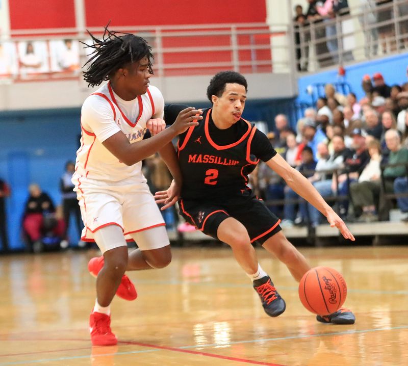 Massillon's Isaiah Lamp handles the basketball against pressure from Alliance's Cashe Brisker, Tuesday, Jan. 6, 2026.