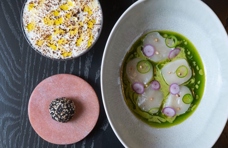 From top left: Meyer Lemon and meringue, scallop kinilaw and piece of toasted marshmallow fudge at Isla