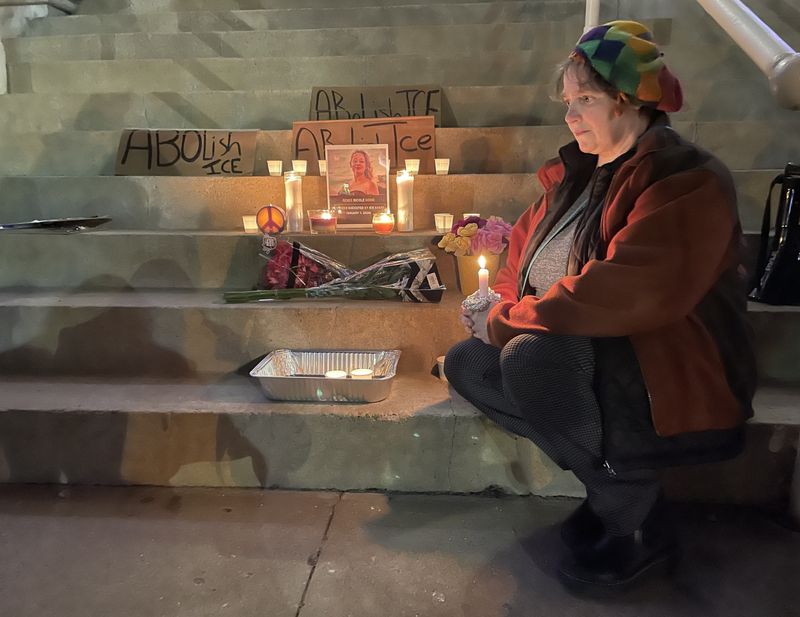 Elizabeth Levin sits and reflects at a candlelight vigil in downtown Zanesville Jan. 8. A group of more than 50 Muskingum County citizens attended the gathering to protest ICE and honor the life of Renee Good, the 37-year-old Minneapolis woman that was killed during an interaction with ICE agents Jan. 7.