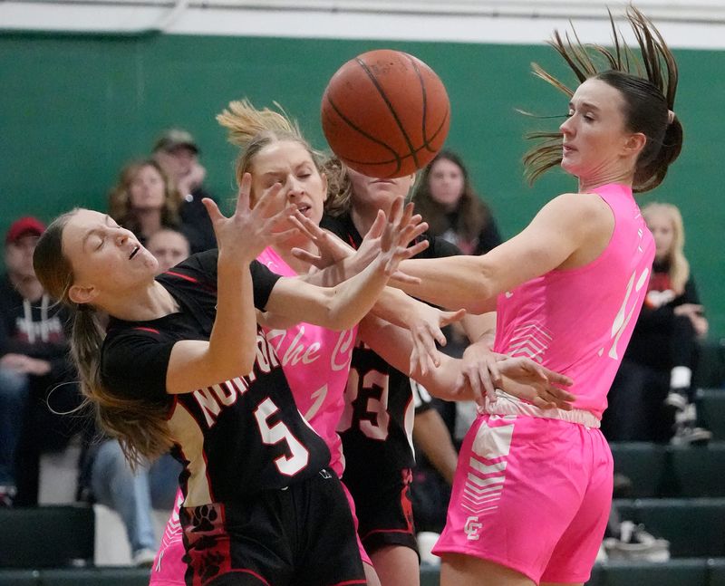 Norton’s Haley Sanderson (5) battles Canton Central Catholic’s Grace Finefrock (1) and Ellie Buckler (11) for a rebound during their game at Canton Central Catholic High School on Jan. 12, 2026.