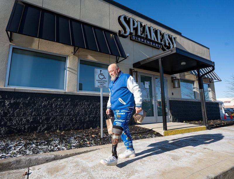 Jeffrey Gabbard leaves Speakeasy Dispensary with two bags of product in Lexington, Kentucky. Gabbard said he uses medical cannabis to help manage chronic pain, stress and anxiety stemming from a 2013 motorcycle crash that resulted in the amputation of his left leg below the knee. Thursday, January 15, 2026.