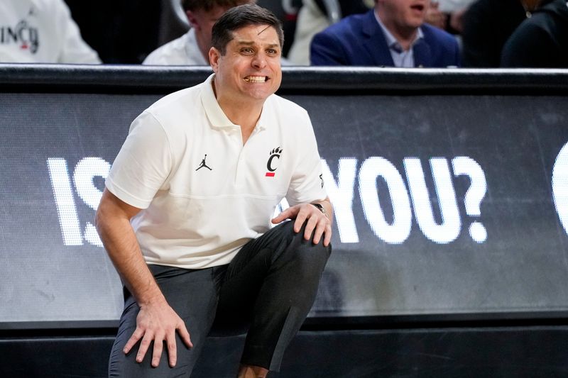 Cincinnati Bearcats head coach Wes Miller reacts to a free throw in the second half of the NCAA Big 12 basketball game between the Cincinnati Bearcats and the Iowa State Cyclones at Fifth Third Stadium in Cincinnati on Saturday, Jan. 17.  The Bearcats upset the No. 2 Cyclones, winning 79-70 for the biggest win of Miller's UC career.