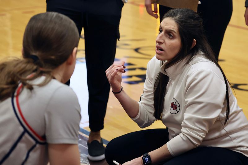 Malone University women's basketball coach Selana Ickes talks to her team during Saturday's game against Thomas More.