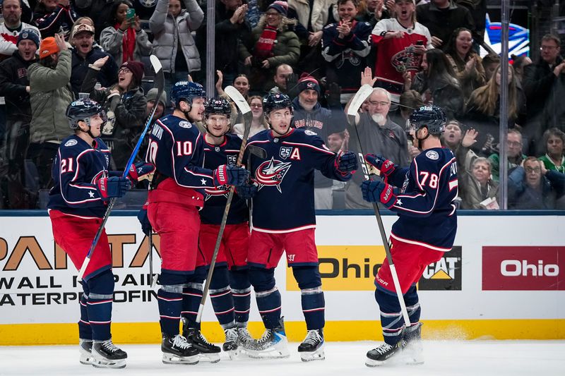 Teammates celebrate a goal by Columbus Blue Jackets defenseman Zach Werenski (8) during the first period of the NHL hockey game against the Dallas Stars at Nationwide Arena in Columbus on Jan. 22, 2026.