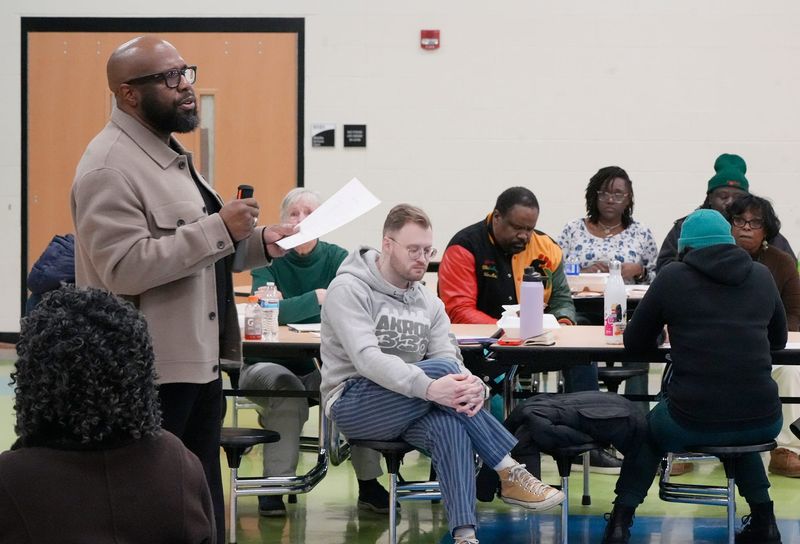 At Large Council member Eric D. Garrett, Sr. speaks at Community Forum Around Policing at Buchtel CLC in Akron on Jan. 22, 2026. Ward 1 Council member Fran Wilson, seated center, also attend the forum.