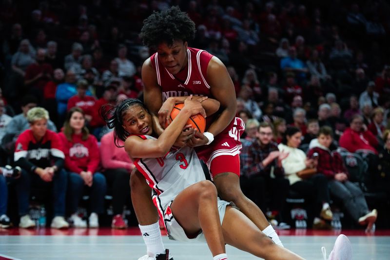Ohio State Buckeyes guard Kennedy Cambridge (3) fights for the ball against Indiana Hoosiers forward Zania Socka-Nguemen (23) in the first half of the NCAA basketball game at Value City Arena on Thursday, Jan. 22, 2026 in Columbus, Ohio.