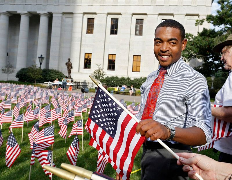 Columbus City Council President Shannon Hardin, then a councilman, plants 9/11 memorial flags at the Ohio Statehouse on Sept. 8, 2016. The annual flag-planting and memorial program at the Statehouse will take place on Sept. 9.