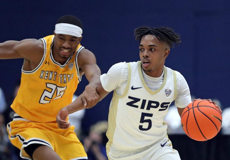 Akron Zips guard Tavari Johnson (5) drives past Kent State Golden Flashes guard Jahari Williamson (25) on Jan. 30, 2026, in Akron.