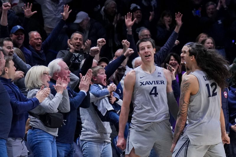 Xavier's Filip Borovicanin celebrates with teammates and fans after his buzzer-beater took down the DePaul Blue Demons 68-66 at the Cintas Center Jan. 31.