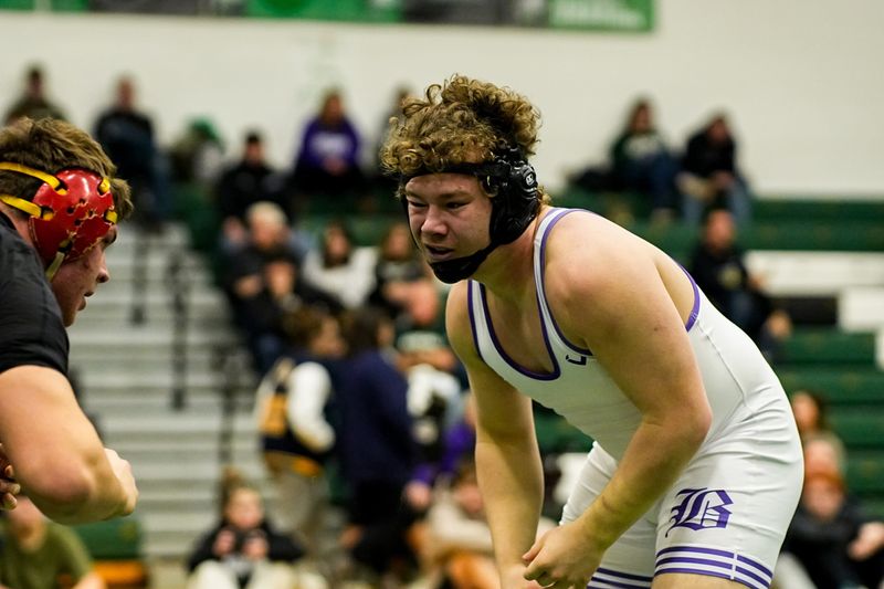 Brecksville’s EJ German, black and red, wrestles Barberton’s Jackson Phillips in a 21b lbs. bout, during the Suburban League wrestling tournament, Jan. 31, 2026, at Highland High School in Granger Township, Ohio.