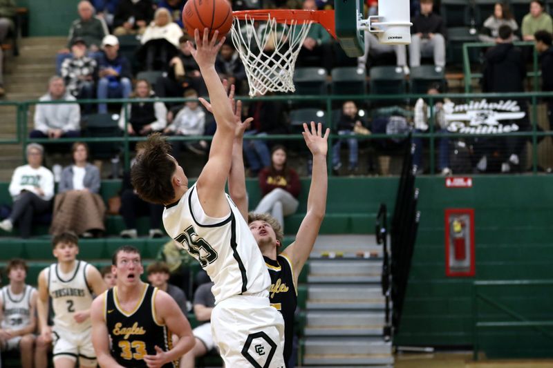 Canton Central Catholic's Will Minor finishes at the hoop over Colonel Crawford's Tyler Lash.