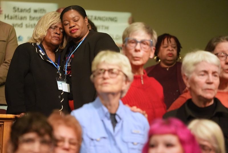 Springfield NAACP President Denise Williams (left) embraces Geurline Jozef of the Haitian Bridge Alliance during a prayer service and faith leaders gathering at St. John Missionary Baptist Church in Springfield, Ohio on Feb 2, 2026. Springfield is home to one of the largest Haitian immigrant communities in the Midwest and a focal point of national political rhetoric.