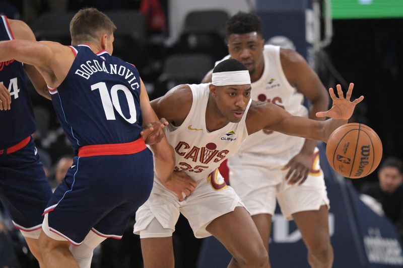 Cavaliers forward Nae'qwan Tomlin steals the ball from Clippers guard Bogdan Bogdanovic (10) in the first half, Feb. 4, 2026, in Inglewood, California.