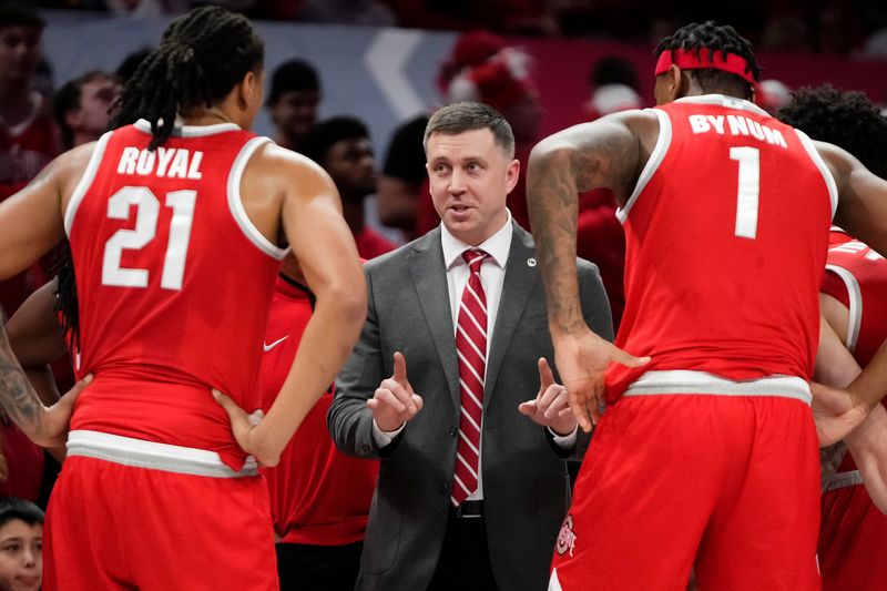 Ohio State Buckeyes head coach Jake Diebler talks to Ohio State Buckeyes forward Amare Bynum (1) and forward Devin Royal (21) during the NCAA men's basketball game against the Michigan Wolverines at the Schottenstein Center in Columbus on Feb. 8, 2026.
