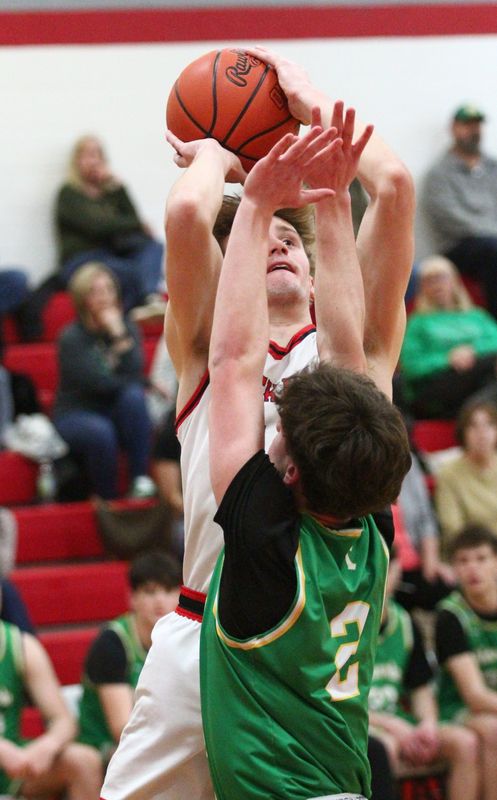 Utica's Hunter McKinney shoots over Newark Catholic's Dylan Daube during host Utica's 70-58 victory on Feb. 10, 2026.