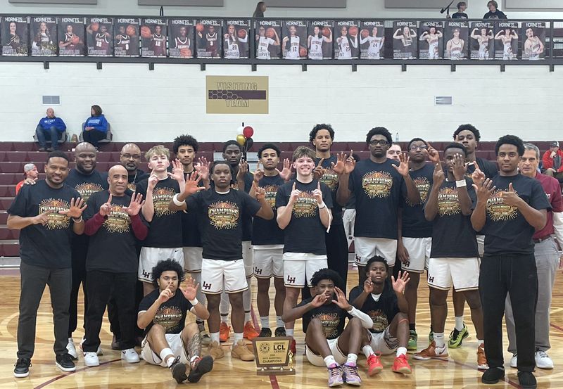 Licking Heights players and coaches hold up six fingers, representing six consecutive LCL-Buckeye Division championships, after they beat visiting Licking Valley 69-52 on senior night on Tuesday, Feb. 10, 2025.