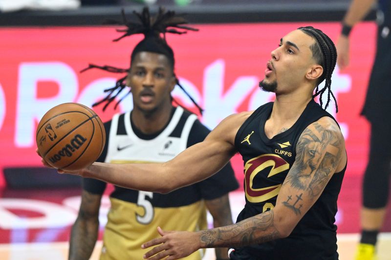 Feb 11, 2026; Cleveland, Ohio, USA; Cleveland Cavaliers guard Jaylon Tyson (20) lays up a shot beside Washington Wizards guard Jamir Watkins (5) in the first quarter at Rocket Arena. Mandatory Credit: David Richard-Imagn Images