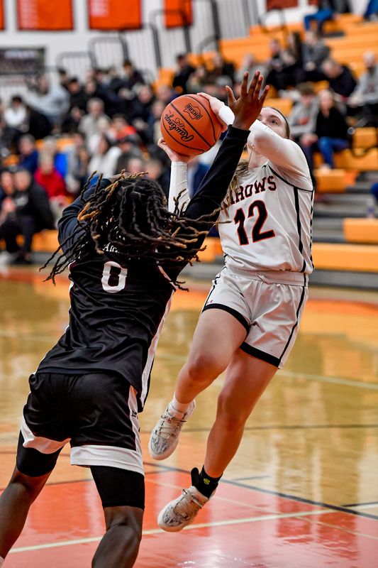 Ashland's Kennedy Lacey puts up a shot over Harvest Prep's Janay Carter.