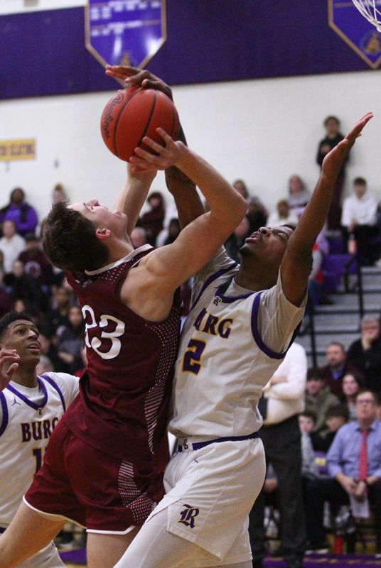 Newark's Jake Quackenbush is defended by Reynoldsburg's Jorden Bowens on Feb. 13.