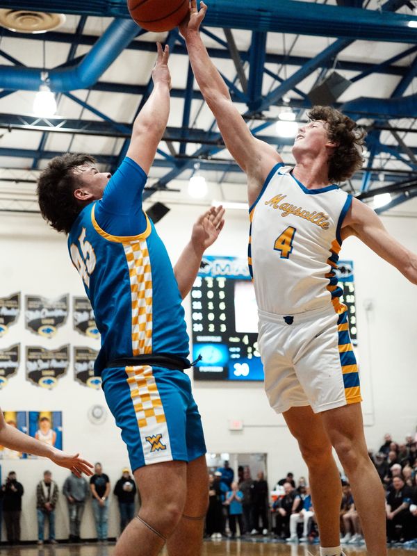 Kade Rock, of Maysville, goes up for a block on Preston Farrell, left, during a 70-68 win against visiting West Muskingum on Friday, Feb. 13, 2026, in Newton Township, Ohio. Maysville won its 20th straight game.