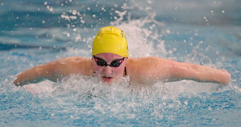 Firestone’s Sarah Schueler competes in the girls 100 yard butterfly event during the OHSAA Division I section swimming meet, Feb. 14, 2026, in Akron, Ohio.
