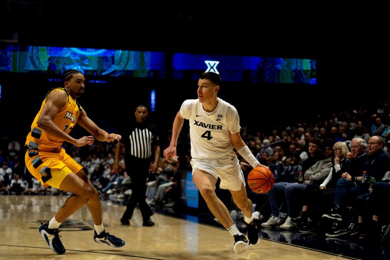 Xavier Musketeers forward Filip Borovicanin (4) drives on Marquette Golden Eagles forward Royce Parham (13) in the second half of the game at the Cintas Center in Cincinnati on Saturday, Feb. 14, 2026.
