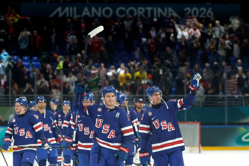 The USA hockey team celebrates after beating Denmark in men's ice hockey during the Milano Cortina 2026 Olympic Winter Games at Milano Santagiulia Ice Hockey Arena in Milan, Italy.