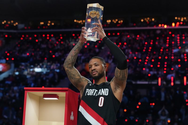 Portland Trail Blazers guard Damian Lillard (0) holds the trophy after winning the 3-point contest