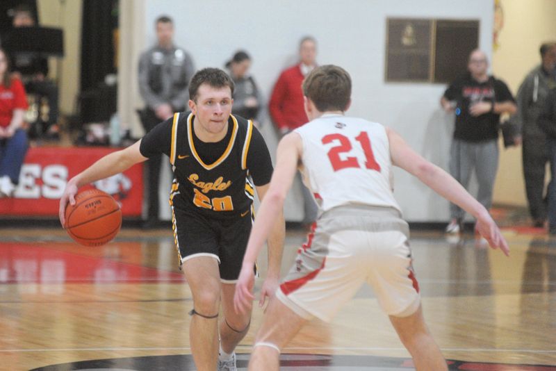 Colonel Crawford's Brayden Holt brings the ball up court with Fredericktown's Carson Rinehart pressuring.