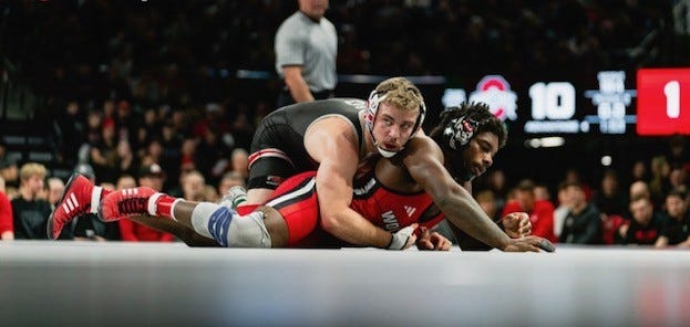 Aurora graduate Dylan Fishback, top, as found a renewed drive with Ohio State after transferring to the Buckeyes last year.