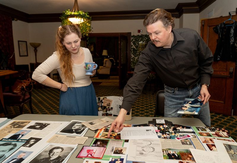 "Man of La Mancha" director Tess Burgler and star Sean Anderson look over theater memorabilia from the late Alfred Anderson, Sean's father, at Ohio Shakespeare Festival.