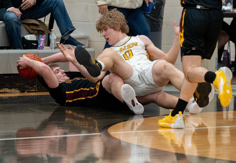 Joe Sharish with possession after a loose ball battle with Colton Miller. Garfield host Southeast boys basketball in Garrettsville on Feb. 20, 2026.