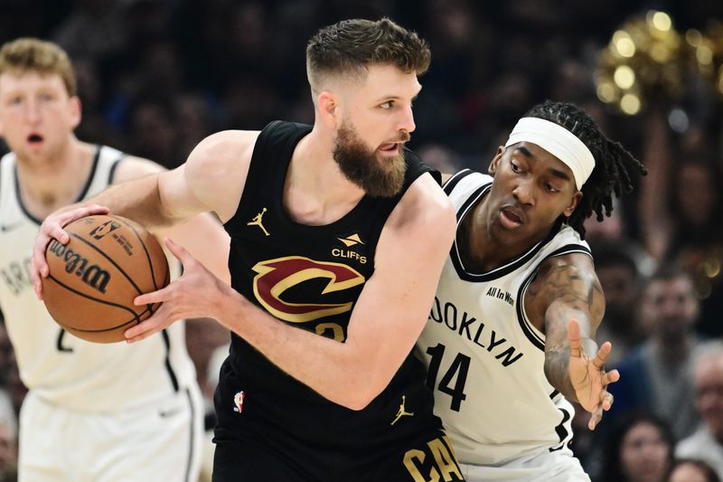 Brooklyn Nets guard Terance Mann defends Cavaliers forward Dean Wade during the first half, Feb. 19, 2026, in Cleveland.
