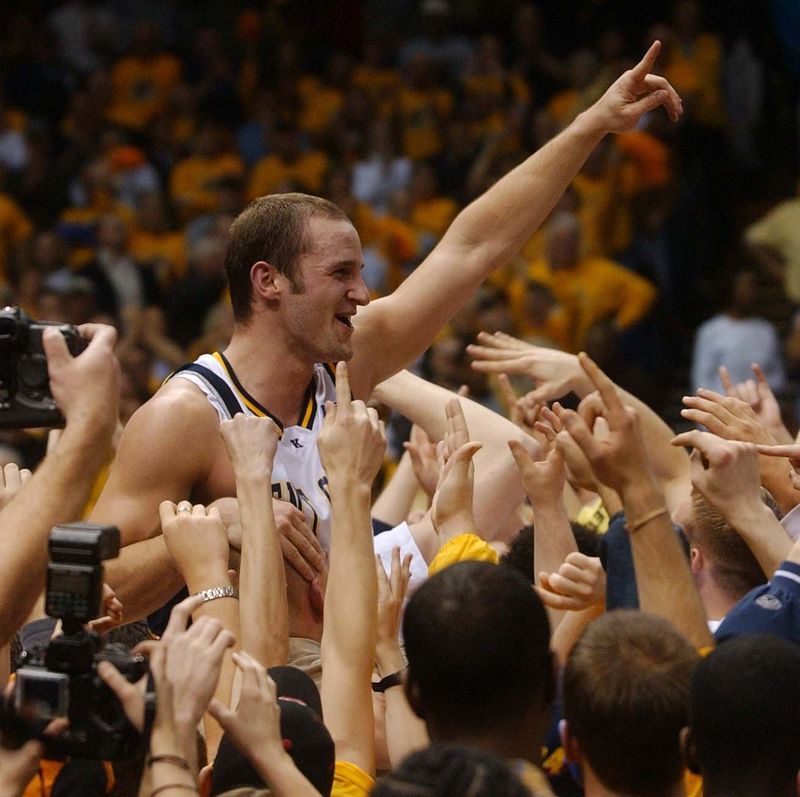 Trevor Huffman of Kent State is lifted by fans after KSU defeated Bowling Green in the MAC championship game at Gund Arena in Cleveland on March 9, 2002.