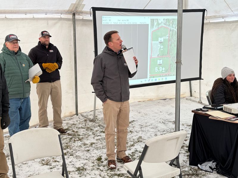 Auctioneer Andy White addresses bidders Monday at the auction of the former Madison Junior High School property.